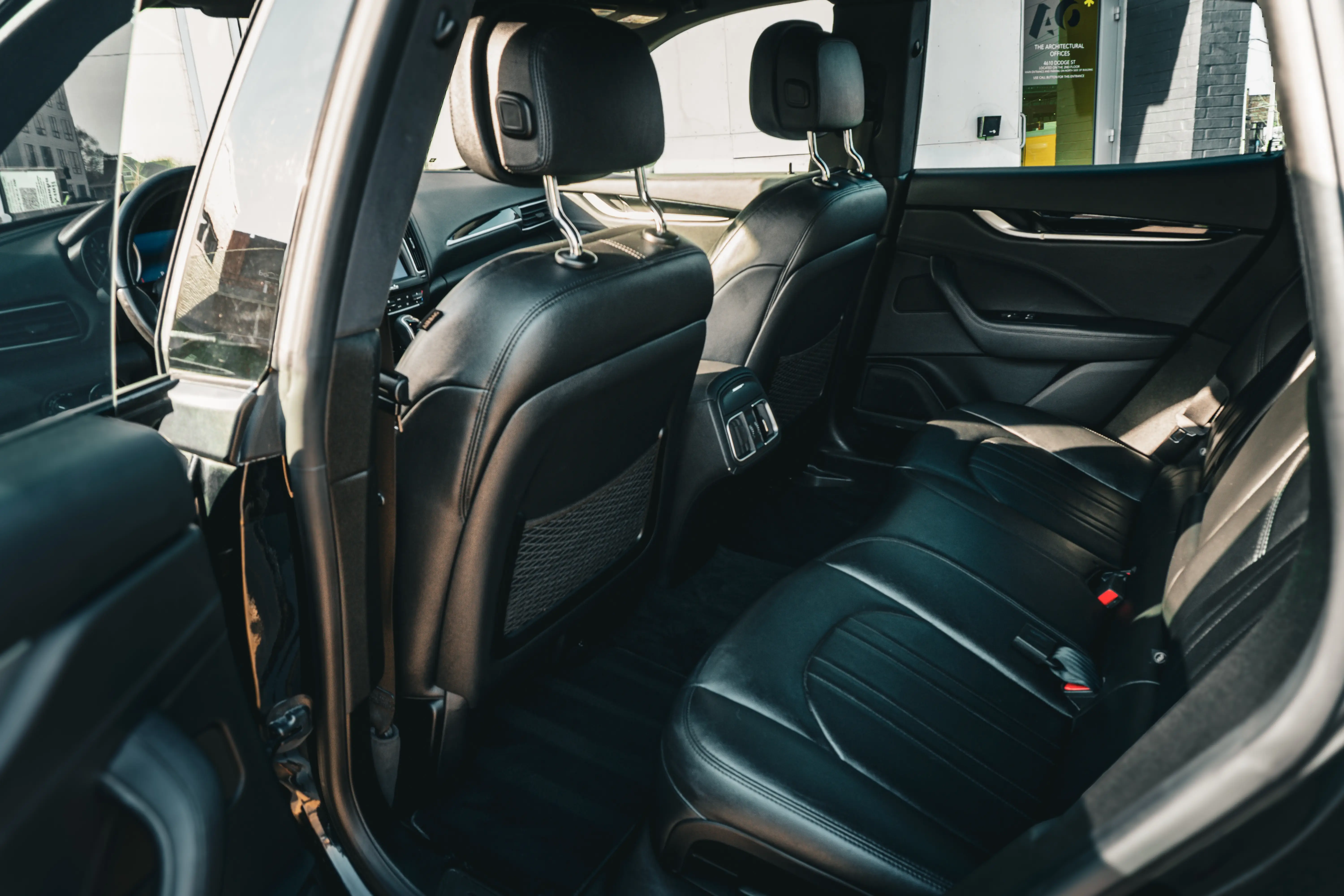 Interior detailing of luxury vehicle rear seats - Signature Auto Detailing